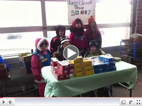 Troop 50807 sings at a cookie booth