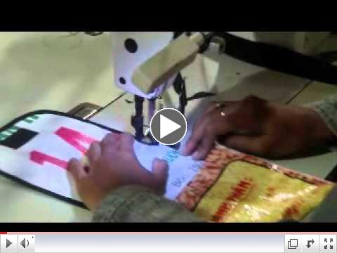 A STOPstart worker sewing one of our bags