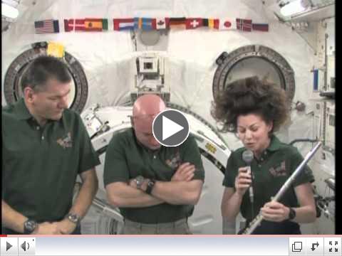 Astronaut Cady Coleman plays flute on space station