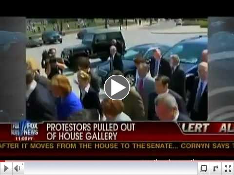 Nancy Pelosi walks past protestors with big gavel.mov