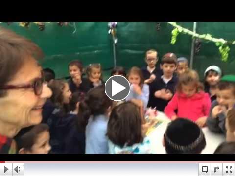 Hillel Academy first graders went to Beacon Place to sing and bring Sukkot decorations. 